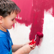boy painting the wall red
